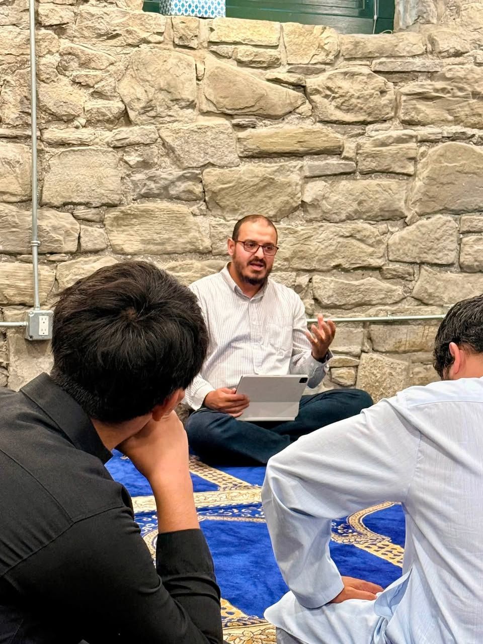Community members listening during an adult Islamic education class